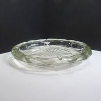 Vintage round clear glass decorative cigar and cigarette ashtray with a starburst design in the center and a criscross X pattern on the side. Side View - Click to enlarge