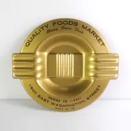 Quality Foods Market round metal salesman sample vintage ashtray with wings. Gold with black graphics: Top View
