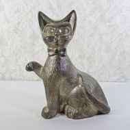 Vintage Siamese cat metal bank with original metal stopper. Wearing a bow tie, one paw is raised in a wavelike pose: Front View