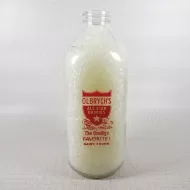 Olbrych's Dairy vintage clear glass acl one quart milk bottle with red graphics and textured body: Front