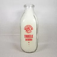Thiele Dairy vintage clear glass acl one quart milk bottle with red graphics: Front