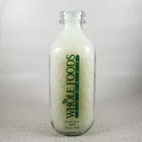 Whole Foods Market Floresville Texas StanPac clear glass square one quart milk bottle with green graphics: Front - Click to enlarge