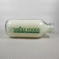 Whole Foods Market Floresville Texas StanPac clear glass square one quart milk bottle with green graphics: Front Flat - Click to enlarge