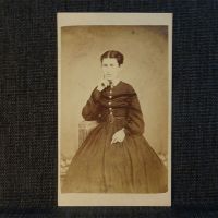 Antique CDV Carte De Visite: Woman from the ankle area up, finger to her cheek wearing a dark, flowing dress: Front View - Click to enlarge