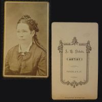 Antique CDV Carte De Visite: Woman from the waist area up with tight ringlet curls and a straight line smile: Front and Back View - Click to enlarge