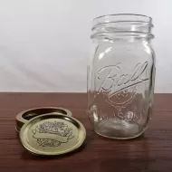 Vintage Ball mason jar with measuring increments on sides of the jar. Design on gold lid and back: Lid Off