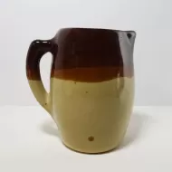 Antique glazed stoneware pitcher with handle. Brown top, beige bottom, band of a third color separating them: Right