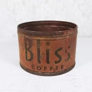Bliss Coffee vintage round metal coffee tin with black graphics orange background. Rustic Display: Front