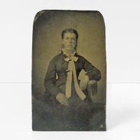 Antique Tintype Photo: Woman sitting on a one armed chair sporting slicked back hair and wearing a long tie: Front View - Click to enlarge