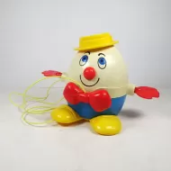 Vintage Fisher Price Humpty Dumpty pull toy with original yellow pull wire. Red hands spin when toy is pulled: Front