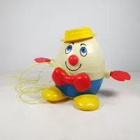 Vintage Fisher Price Humpty Dumpty pull toy with original yellow pull wire. Red hands spin when toy is pulled: Front - Click to enlarge