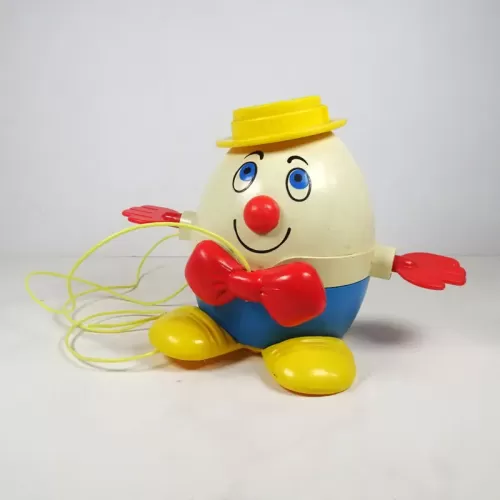 Vintage Fisher Price Humpty Dumpty pull toy with original yellow pull wire. Red hands spin when toy is pulled: Front