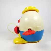 Vintage Fisher Price Humpty Dumpty pull toy with original yellow pull wire. Red hands spin when toy is pulled: Left - Click to enlarge
