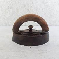 Antique Mrs. Potts sad iron. Cast iron with the half round or "C" wood handle having a metal connector: Main View - Click to enlarge