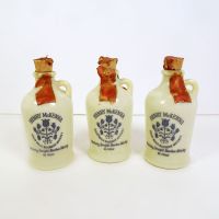 Set of 3 Vintage Miniature McKenna Bourbon Jugs with Corks and Paper Seals: Front View - Click to enlarge