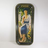 Drink Coca Cola vintage 1973 rectangular metal tray. Girl in blue dress drinking Coke from a glass. Bottle on table: Top View