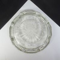Vintage round clear glass decorative cigar and cigarette ashtray with a starburst design in the center and a criscross X pattern on the side. Bottom View - Click to enlarge