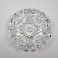 Vintage small round clear glass ashtray with beautiful raised four point star and flower design. Scallop edge: Top