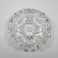 Vintage small round clear glass ashtray with beautiful raised four point star and flower design. Scallop edge: Top - Click to enlarge