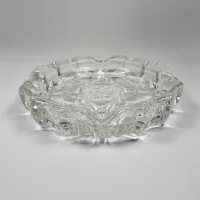 Vintage small round clear glass ashtray with beautiful raised four point star and flower design. Scallop edge: Top-Side - Click to enlarge