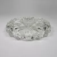 Vintage small round clear glass ashtray with beautiful raised four point star and flower design. Scallop edge: Bottom-Side - Click to enlarge