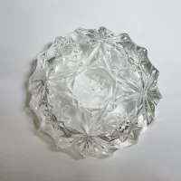 Vintage small round clear glass ashtray with beautiful raised four point star and flower design. Scallop edge: Bottom - Click to enlarge