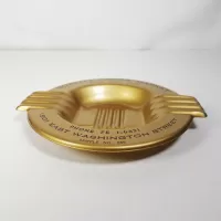 Quality Foods Market round metal salesman sample vintage ashtray with wings. Gold with black graphics: Top Side View - Click to enlarge