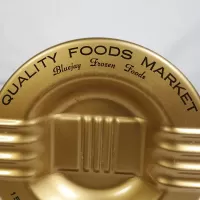 Quality Foods Market round metal salesman sample vintage ashtray with wings. Gold with black graphics: Top Graphics View - Click to enlarge
