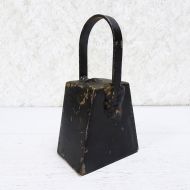 Vintage handmade welded metal cow bell with nut clapper and chipped black paint. Loud ring: Left Side View