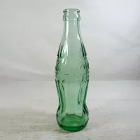 Tampa Florida vintage 6 oz. empty hobbleskirt no refill pat'd Christmas Coke bottle in aqua tinted glass: Left Side - Click to enlarge
