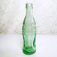 1951 Indiana Evansville vintage empty hobbleskirt PatD Coke bottle with big letters and uneven glass: Left Side View - Click to enlarge