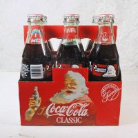 Six 1993 full Seasons Greetings Coca Cola Classic 8 oz soft drink bottles in the original cardboard carton: Front View - Click to enlarge