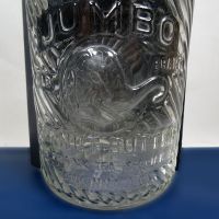 Jumbo Peanut Butter cintage clear glass jar with embossed elephant head: Embossed Front - Click to enlarge