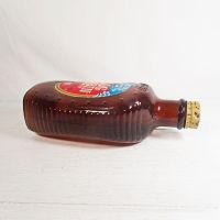 1976 Eagle Log Cabin bicentennial brown glass pancake syrup bottle. Paper label, ribbed sides, metal cap: Side View - Click to enlarge