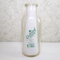 Cloverleaf Dairy in Sandusky, Ohio quart ACL glass milk bottle. Graphics show a baby laying in a crib holding a baby bottle: Front View - Click to enlarge