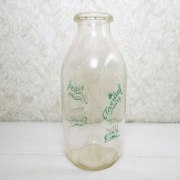 Cloverleaf Dairy in Sandusky, Ohio quart ACL glass milk bottle. Graphics show a baby laying in a crib holding a baby bottle: Right View - Click to enlarge
