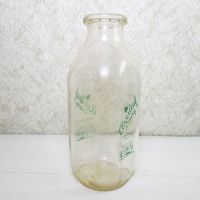 Cloverleaf Dairy in Sandusky, Ohio quart ACL glass milk bottle. Graphics show a baby laying in a crib holding a baby bottle: Left View - Click to enlarge