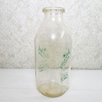 Cloverleaf Dairy in Sandusky, Ohio quart ACL glass milk bottle. Graphics show a baby laying in a crib holding a baby bottle: Left View - Click to enlarge