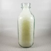 Whole Foods Market Floresville Texas StanPac clear glass square one quart milk bottle with green graphics: Left - Click to enlarge