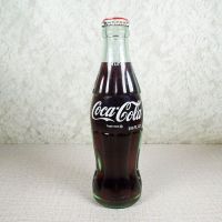 No Location vintage 6-1/2 oz full Coke bottle with white painted graphics and red Coca Cola Classic cap: Front - Click to enlarge