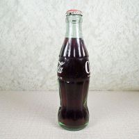 No Location vintage 6-1/2 oz full Coke bottle with white painted graphics and red Coca Cola Classic cap: Left - Click to enlarge