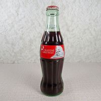 1991 Seasons Greetings full Classic Coke bottle. Santa’s face in white and black on a red background: Front - Click to enlarge