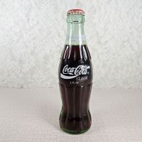 1991 Seasons Greetings full Classic Coke bottle. Santa’s face in white and black on a red background: Back - Click to enlarge