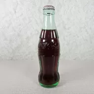 Ottumwa Iowa vintage 8 oz full hobbleskirt no refill Coke bottle with Coca Cola Classic cap: Front