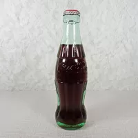 Ottumwa Iowa vintage 8 oz full hobbleskirt no refill Coke bottle with Coca Cola Classic cap: Back - Click to enlarge