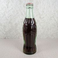 Kearney Nebraska vintage 6 oz full hobbleskirt Coke bottle with red Coca Cola Classic cap: Left - Click to enlarge
