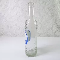1967 Sun Crest Long Neck 10 oz Vintage ACL Soda Bottle. Blue white graphics. Raised ovals. #5a: Left - Click to enlarge