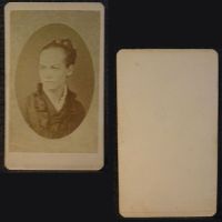 Antique CDV Carte De Visite: Woman from the shoulder area up with a braided bun, straight line smile and ruffled collar: Front and Back View - Click to enlarge