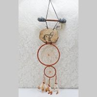 Dream Catcher with image of a howling wolf imprinted on a rock hanging from a stick and two webbed hoops. Feathers and beads: Front View - Click to enlarge