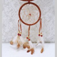 Dream Catcher with image of a howling wolf imprinted on a rock hanging from a stick and two webbed hoops. Feathers and beads: Bottom Dream Catcher View - Click to enlarge
